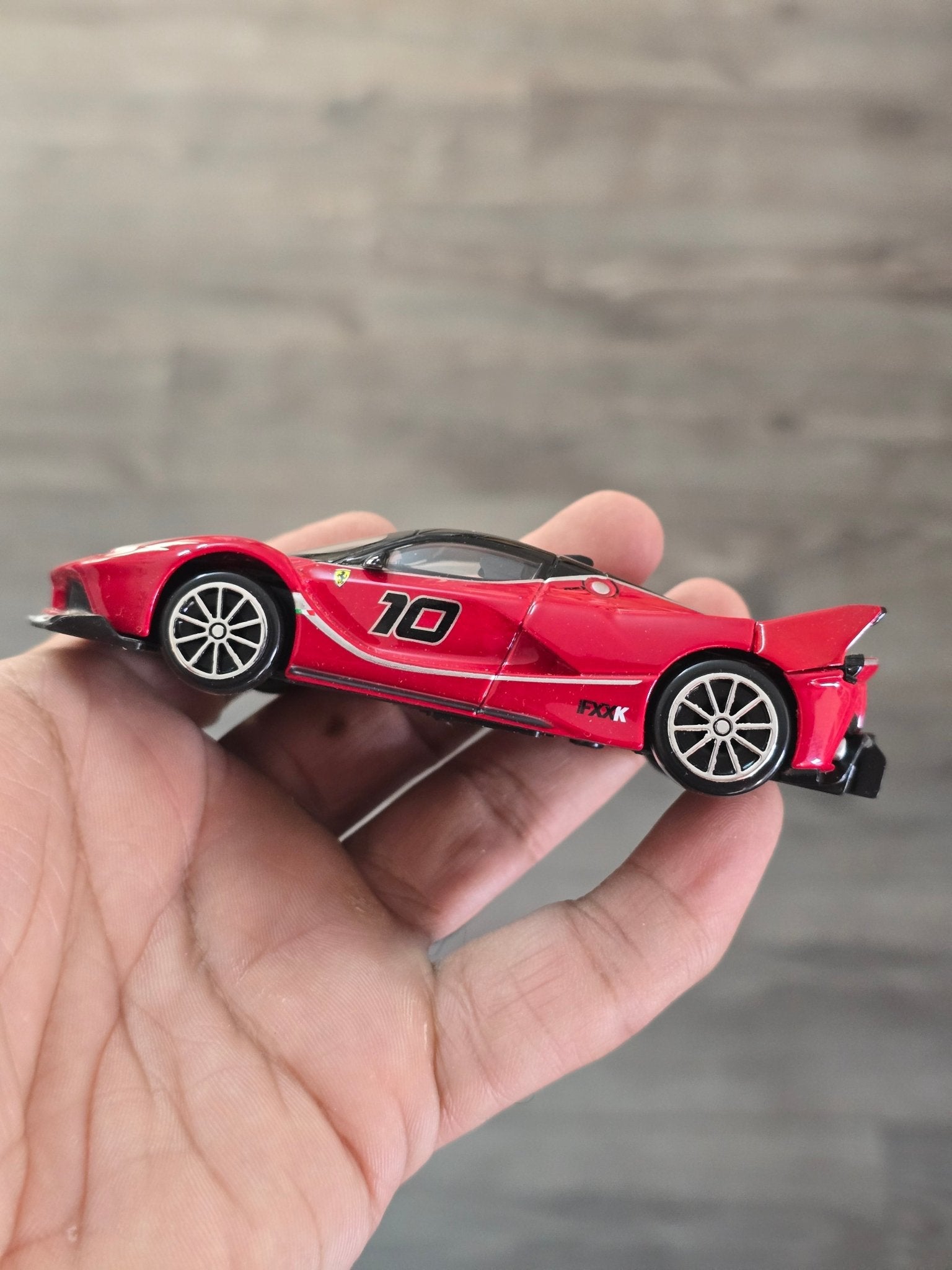 1:43 Bburago Ferrari FXX K Number 10 - Red (Uncarded - New) - Kinder Logs