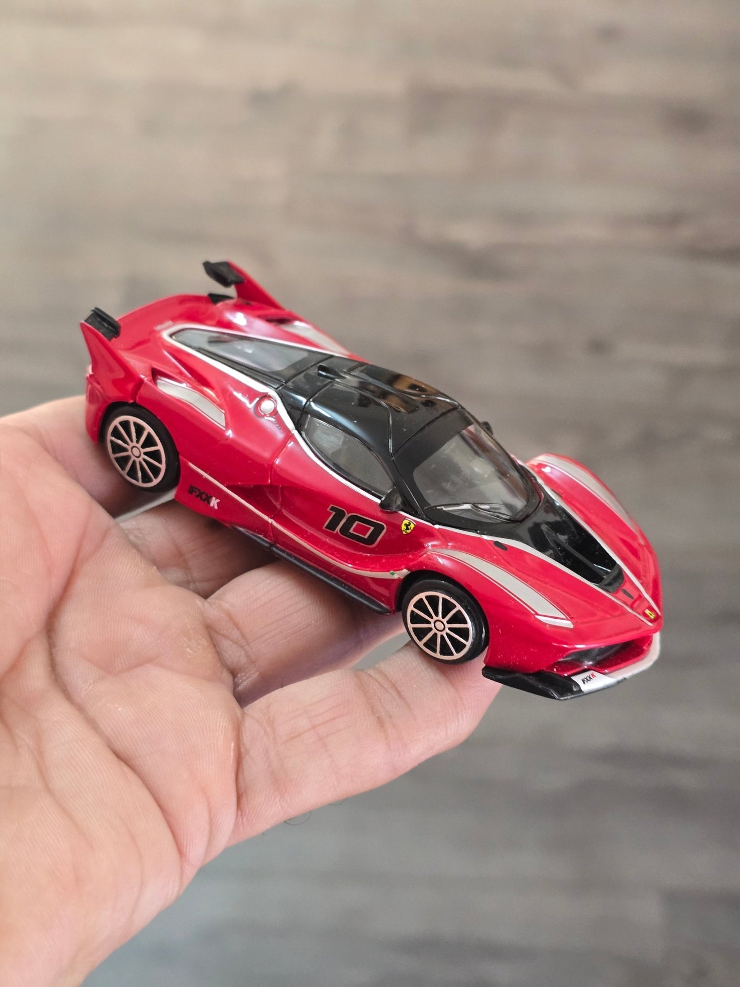 1:43 Bburago Ferrari FXX K Number 10 - Red (Uncarded - New) - Kinder Logs