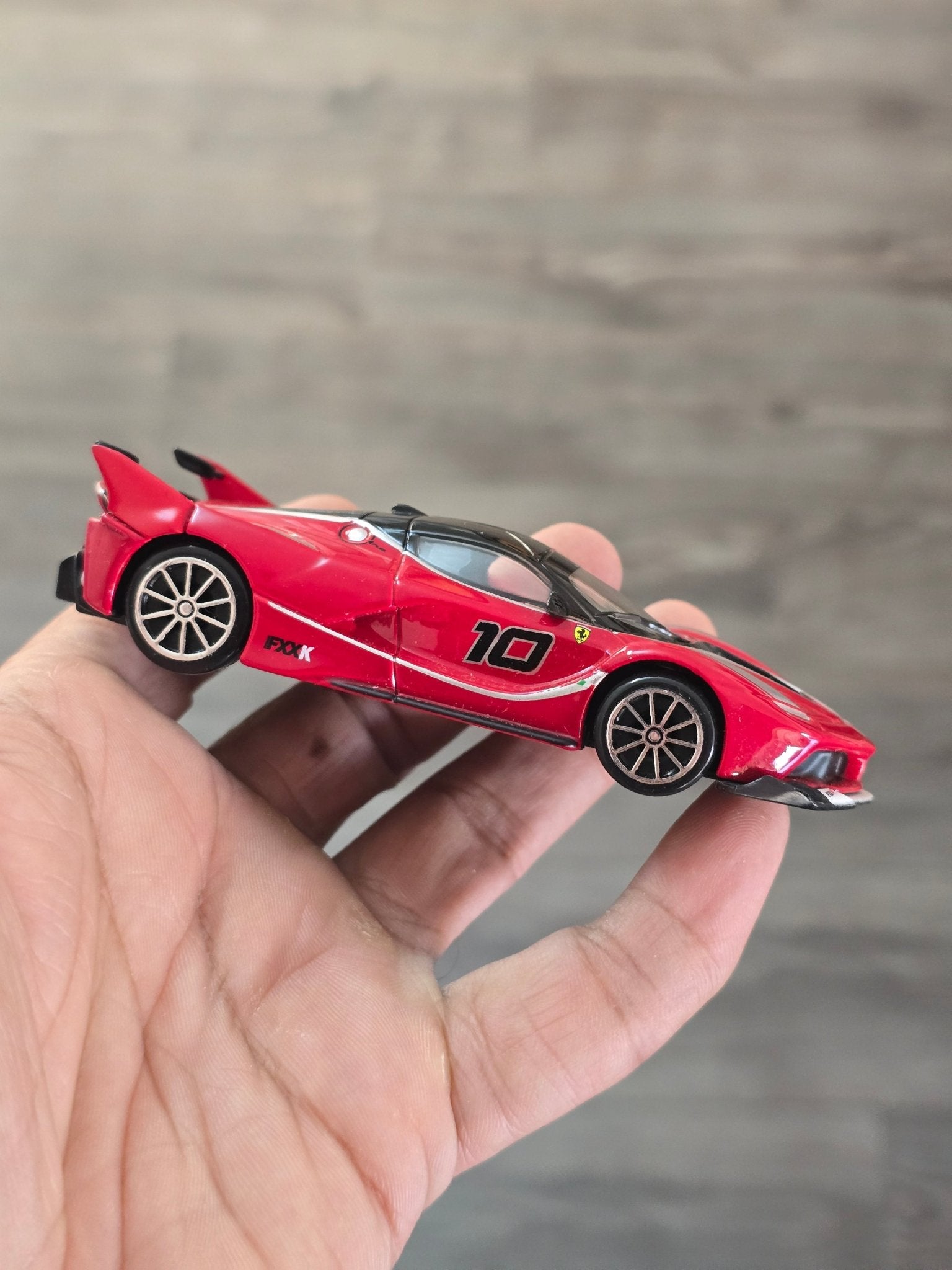 1:43 Bburago Ferrari FXX K Number 10 - Red (Uncarded - New) - Kinder Logs