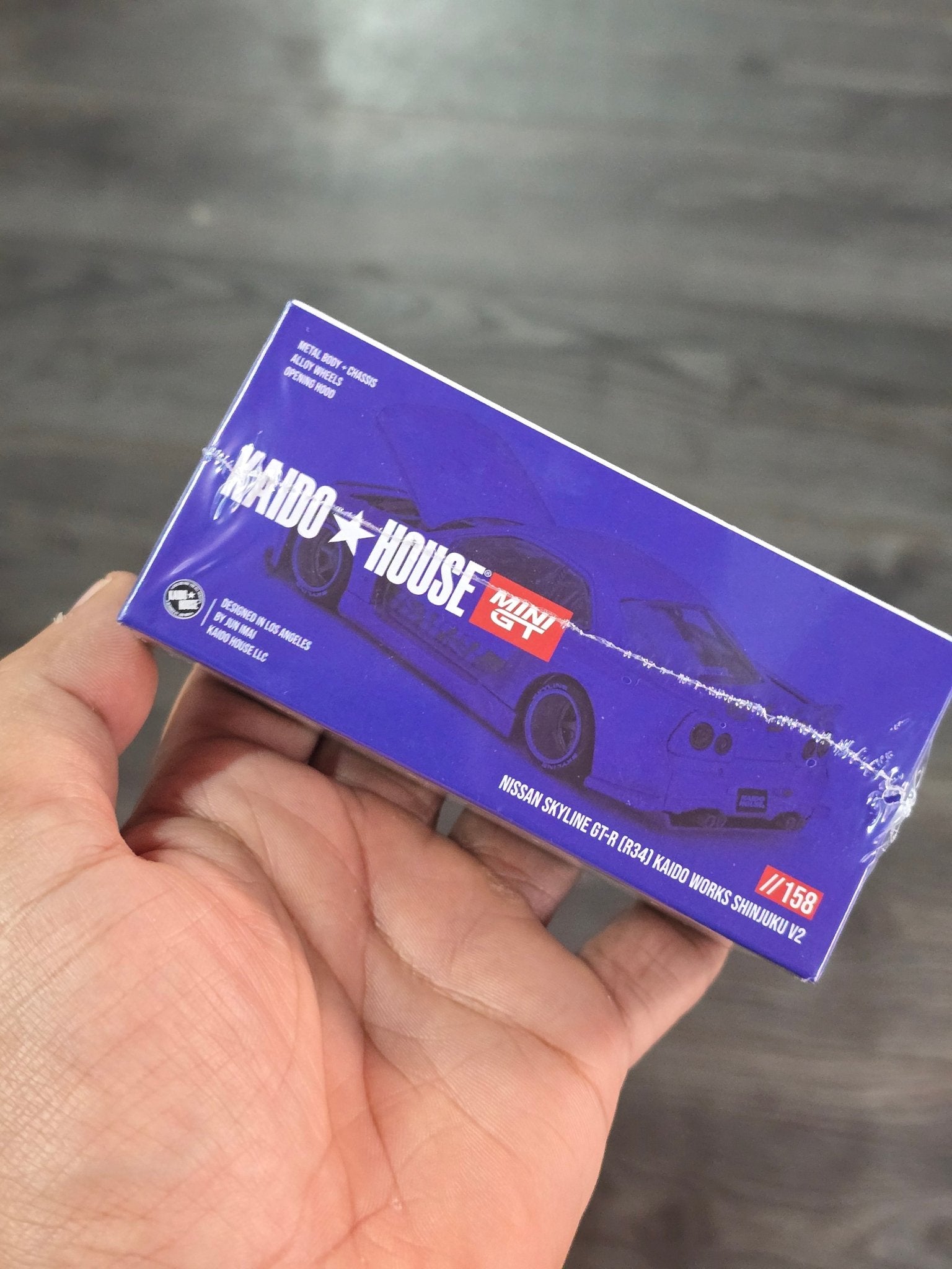 Mini GT Nissan Skyline GT - R (R34) Kaido Works Shinjuku V2 (Blue) - Kinder Logs