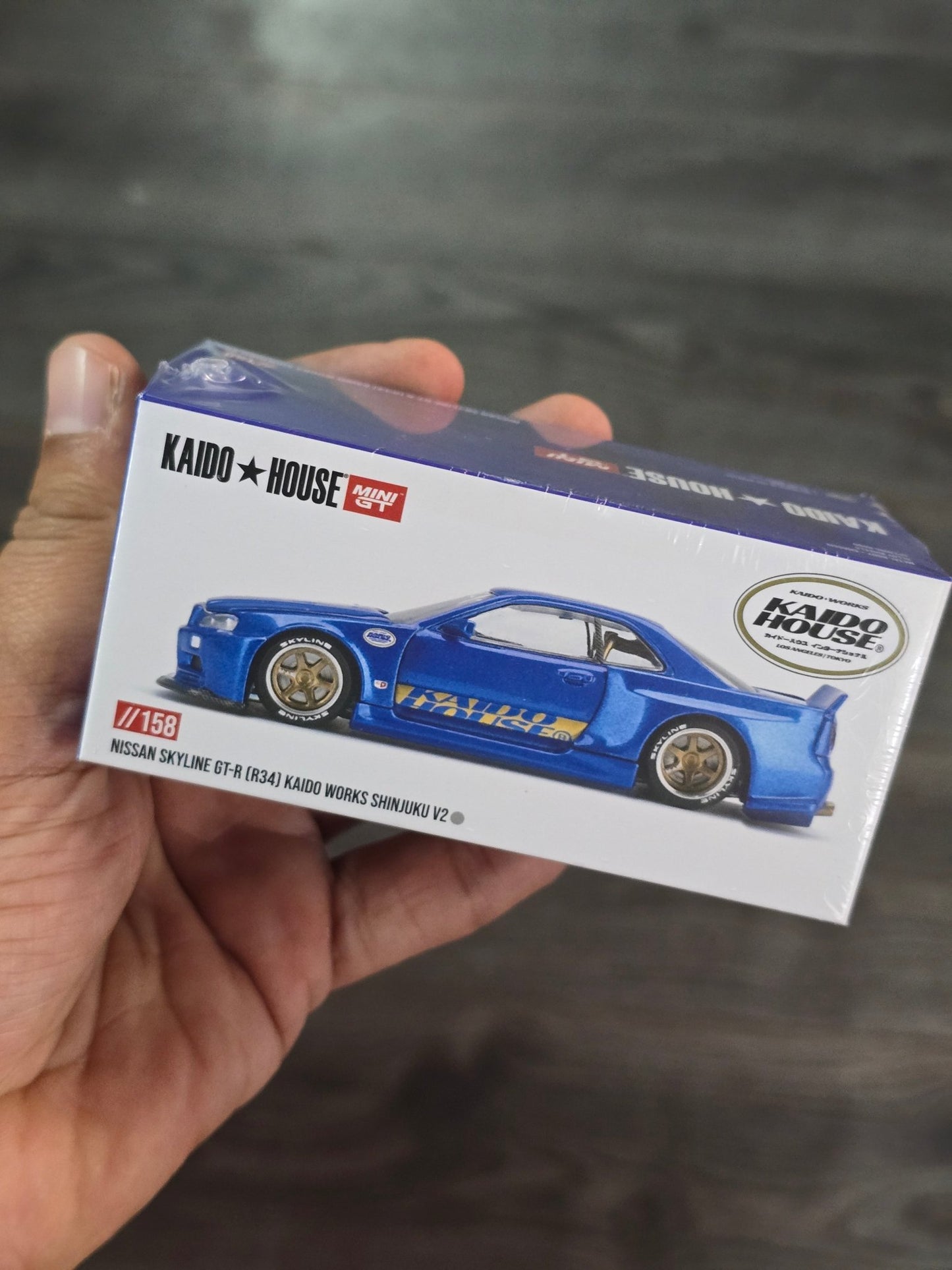 Mini GT Nissan Skyline GT - R (R34) Kaido Works Shinjuku V2 (Blue) - Kinder Logs