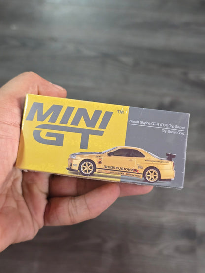 Mini GT Nissan Skyline GT - R (R34) Top Secret (Gold) - Sealed Box - Kinder Logs